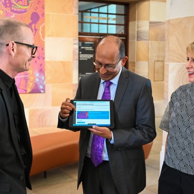 UQ Chancellor Peter Varghese shows staff early adopters, Professor Greg Hainge (left) and Sybilla Wilson (right) the Core Cultural Learning website.